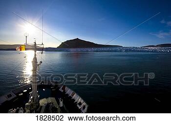 Stock Photo - ship bow approaching 
iceberg at dusk, 
nunavut, canada. 
fotosearch - search 
stock photos, 
pictures, images, 
and photo clipart