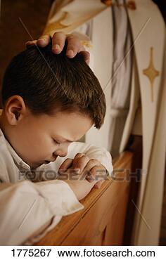 Picture - priest praying 
for young boy. 
fotosearch - search 
stock photos, 
pictures, images, 
and photo clipart