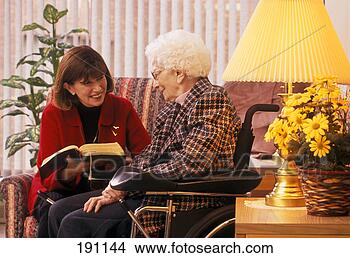 Stock Photo - woman reading 
to senior relative 
on wheelchair. 
fotosearch - search 
stock photos, 
pictures, images, 
and photo clipart