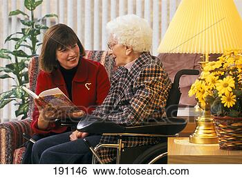 Stock Photo - woman reading 
to senior relative 
in wheelchair. 
fotosearch - search 
stock photos, 
pictures, images, 
and photo clipart
