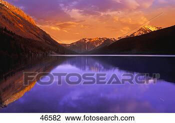 Stock Photo - calm lake with 
mountain behind. 
fotosearch - search 
stock photos, 
pictures, images, 
and photo clipart