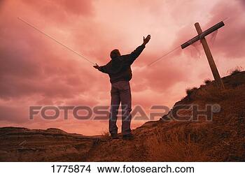 Stock Photo - man at cross with 
raised arms. fotosearch 
- search stock 
photos, pictures, 
images, and photo 
clipart