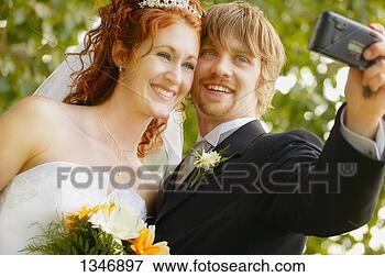 Picture - newly married 
couple takes first 
photo. fotosearch 
- search stock 
photos, pictures, 
images, and photo 
clipart