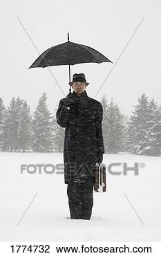 Stock Photo - businessman waiting 
in the snow with 
umbrella and briefcase. 
fotosearch - search 
stock photos, 
pictures, images, 
and photo clipart
