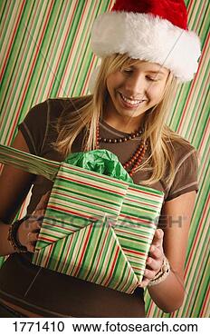 Stock Photography - girl with christmas 
present. fotosearch 
- search stock 
photos, pictures, 
images, and photo 
clipart