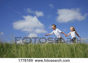 Stock Photograph - boy & girl running 
in tall grass. 
fotosearch - search 
stock photos, 
pictures, images, 
and photo clipart