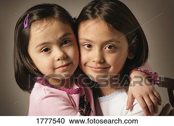 Stock Photography - two sisters hugging. 
fotosearch - search 
stock photos, 
pictures, images, 
and photo clipart