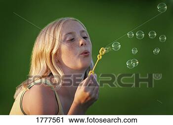 Stock Photography - a girl blows bubbles. 
fotosearch - search 
stock photos, 
pictures, images, 
and photo clipart