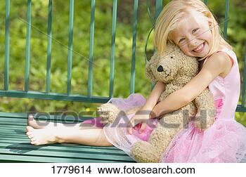Stock Photo - girl hugs teddy 
bear. fotosearch 
- search stock 
photos, pictures, 
images, and photo 
clipart