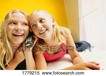 Stock Image - girls listen on 
phone. fotosearch 
- search stock 
photos, pictures, 
images, and photo 
clipart