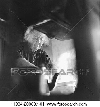 Stock Photography - portrait of elderly 
woman cooking 
by stove. fotosearch 
- search stock 
photos, pictures, 
images, and photo 
clipart