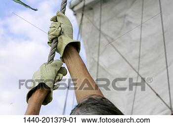 Stock Photography - hoisting the sail 
on a sailboat. 
fotosearch - search 
stock photos, 
pictures, images, 
and photo clipart