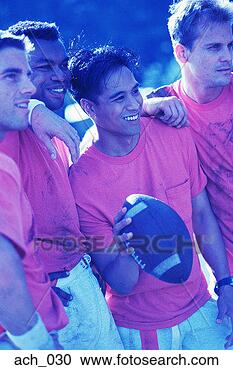 Stock Photography - group of football 
players; one holding 
football. fotosearch 
- search stock 
photos, pictures, 
images, and photo 
clipart