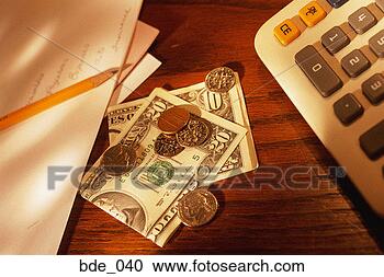 Stock Photography - american paper 
money and coins 
on desktop; adding 
machine on one. 
fotosearch - search 
stock photos, 
pictures, images, 
and photo clipart