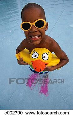 Stock Photography - boy in pool with 
inflatable ring 
in shape of duck 
around waist. 
fotosearch - search 
stock photos, 
pictures, images, 
and photo clipart