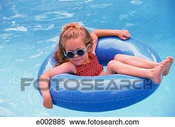 Stock Image - girl floating 
on inflatable 
ring in pool. 
fotosearch - search 
stock photos, 
pictures, images, 
and photo clipart