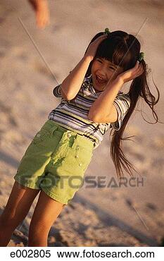 Stock Image - girl putting up 
arms to shield 
face, laughing. 
fotosearch - search 
stock photos, 
pictures, images, 
and photo clipart