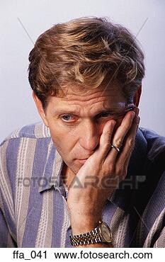 Stock Photography - man leaning head 
on hand, looking 
to side. fotosearch 
- search stock 
photos, pictures, 
images, and photo 
clipart