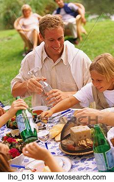 Stock Photo - family group eating 
at picnic table. 
fotosearch - search 
stock photos, 
pictures, images, 
and photo clipart