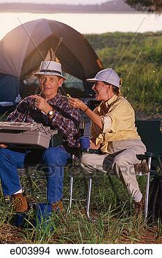 Stock Photo - couple camping 
and baiting fishing 
pole. fotosearch 
- search stock 
photos, pictures, 
images, and photo 
clipart