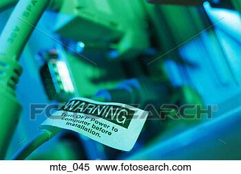 Stock Image - cords plugged 
into back of computer, 
and warning tag. 
fotosearch - search 
stock photos, 
pictures, images, 
and photo clipart