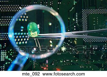 Stock Photo - magnifying glass 
showing tweezers 
holding light-emitting 
diode over. fotosearch 
- search stock 
photos, pictures, 
images, and photo 
clipart