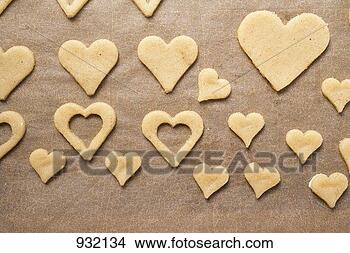 Stock Photo - cut-out biscuits 
on baking parchment. 
fotosearch - search 
stock photos, 
pictures, images, 
and photo clipart