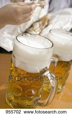 Stock Photo - litres of beer 
& steckerlfisch 
(fish on stick, 
oktoberfest, munich). 
fotosearch - search 
stock photos, 
pictures, images, 
and photo clipart