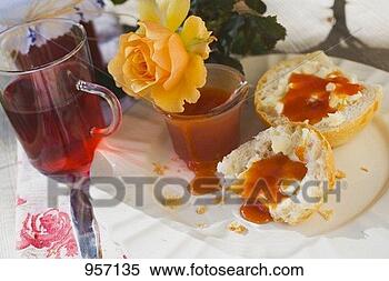 Stock Image - rose hip jam on 
bread roll, jar 
of jam, rose hip 
tea, yellow rose. 
fotosearch - search 
stock photos, 
pictures, images, 
and photo clipart