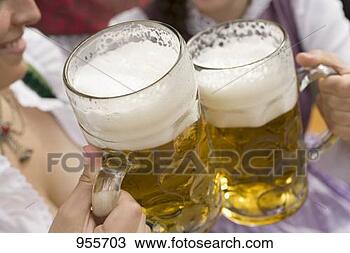 Stock Photo - hands clinking 
litres of beer 
together (oktoberfest, 
munich). fotosearch 
- search stock 
photos, pictures, 
images, and photo 
clipart