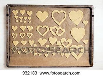 Stock Photo - cut-out biscuits 
on a baking tray. 
fotosearch - search 
stock photos, 
pictures, images, 
and photo clipart