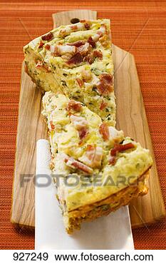 Stock Photograph - two pieces of 
leek and bacon 
quiche on chopping 
board. fotosearch 
- search stock 
photos, pictures, 
images, and photo 
clipart