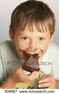 Picture - boy eating a piece 
of chocolate cake. 
fotosearch - search 
stock photos, 
pictures, images, 
and photo clipart