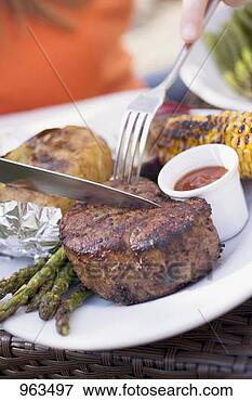 Picture - person eating 
grilled beef steak. 
fotosearch - search 
stock photos, 
pictures, images, 
and photo clipart
