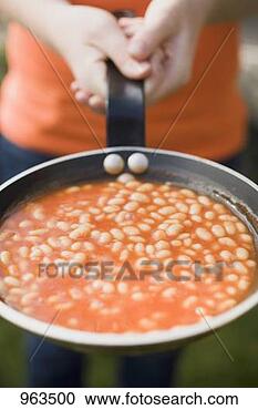 Stock Photography - person holding 
a pan of baked 
beans. fotosearch 
- search stock 
photos, pictures, 
images, and photo 
clipart