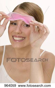 Stock Photograph - woman with a cooling 
eye mask. fotosearch 
- search stock 
photos, pictures, 
images, and photo 
clipart