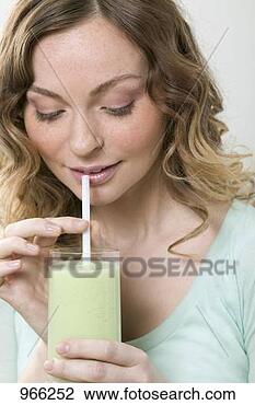 Stock Photo - woman drinking 
cucumber shake 
through a straw. 
fotosearch - search 
stock photos, 
pictures, images, 
and photo clipart