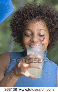 Stock Photo - woman drinking 
lemonade at a 
garden party. 
fotosearch - search 
stock photos, 
pictures, images, 
and photo clipart