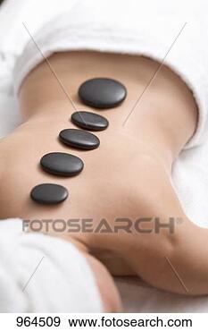 Stock Photograph - woman having hot 
stone therapy 
(healing therapy 
using stones). 
fotosearch - search 
stock photos, 
pictures, images, 
and photo clipart