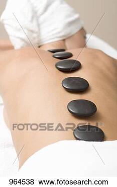 Stock Photo - woman having hot 
stone therapy 
(healing therapy 
using stones). 
fotosearch - search 
stock photos, 
pictures, images, 
and photo clipart