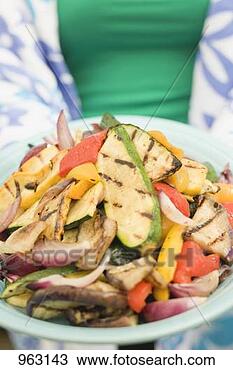 Stock Photo - woman holding 
a plate of grilled 
vegetables. fotosearch 
- search stock 
photos, pictures, 
images, and photo 
clipart