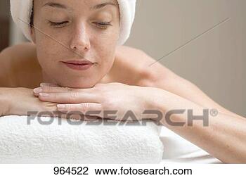 Stock Photo - woman lying down, 
resting on white 
towel. fotosearch 
- search stock 
photos, pictures, 
images, and photo 
clipart