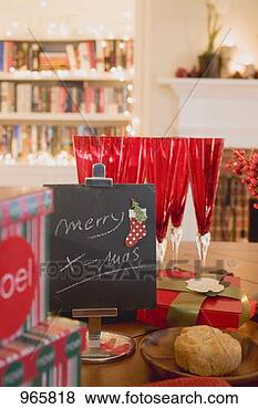 Stock Photo - xmas decorations 
& glasses on dining 
table in front 
of fireplace. 
fotosearch - search 
stock photos, 
pictures, images, 
and photo clipart