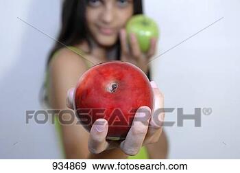 Stock Photograph - young woman holding 
one red and one 
green apple. fotosearch 
- search stock 
photos, pictures, 
images, and photo 
clipart