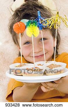 Stock Photo - boy holding out 
a tray of muffins. 
fotosearch - search 
stock photos, 
pictures, images, 
and photo clipart