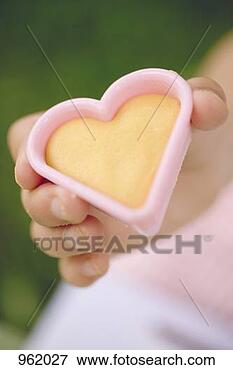 Picture - child holding 
cut-out biscuit. 
fotosearch - search 
stock photos, 
pictures, images, 
and photo clipart