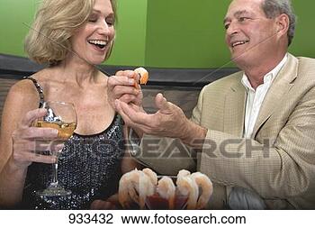 Stock Photo - man and woman 
eating shrimps 
in restaurant. 
fotosearch - search 
stock photos, 
pictures, images, 
and photo clipart