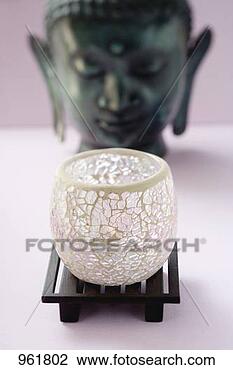 Stock Photo - windlight in front 
of statue of buddha. 
fotosearch - search 
stock photos, 
pictures, images, 
and photo clipart