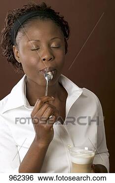 Stock Photo - woman enjoying 
the milk froth 
from a latte macchiato. 
fotosearch - search 
stock photos, 
pictures, images, 
and photo clipart