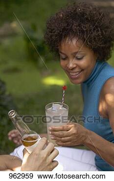 Stock Photograph - woman with a glass 
of lemonade at 
a garden party. 
fotosearch - search 
stock photos, 
pictures, images, 
and photo clipart